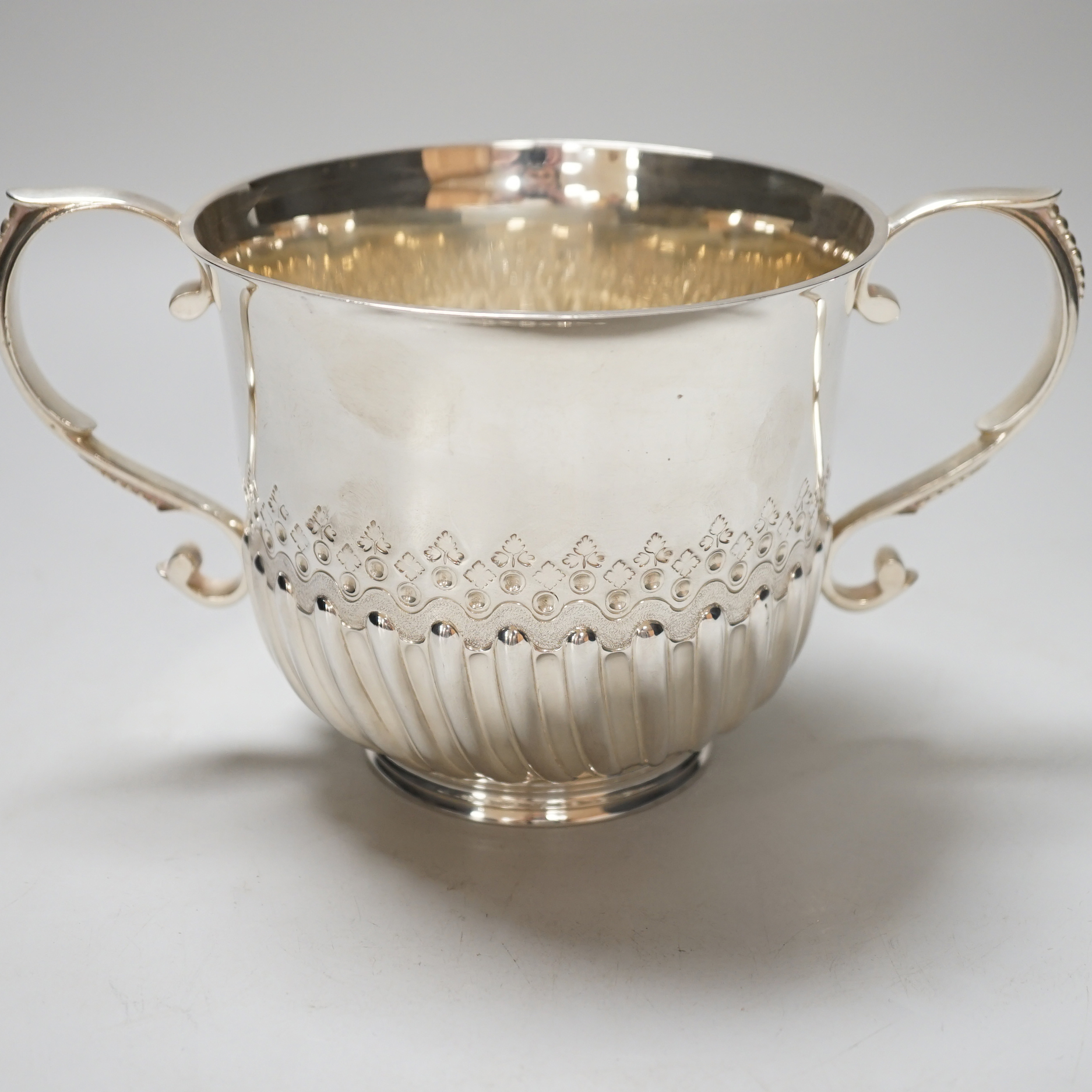 A Victorian silver loving cup, with scroll handles and demi-fluted body, London 1878, 21cm over the handles, 410 grams
